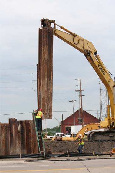 A crew lifts and sets heavy steel on a jobsite